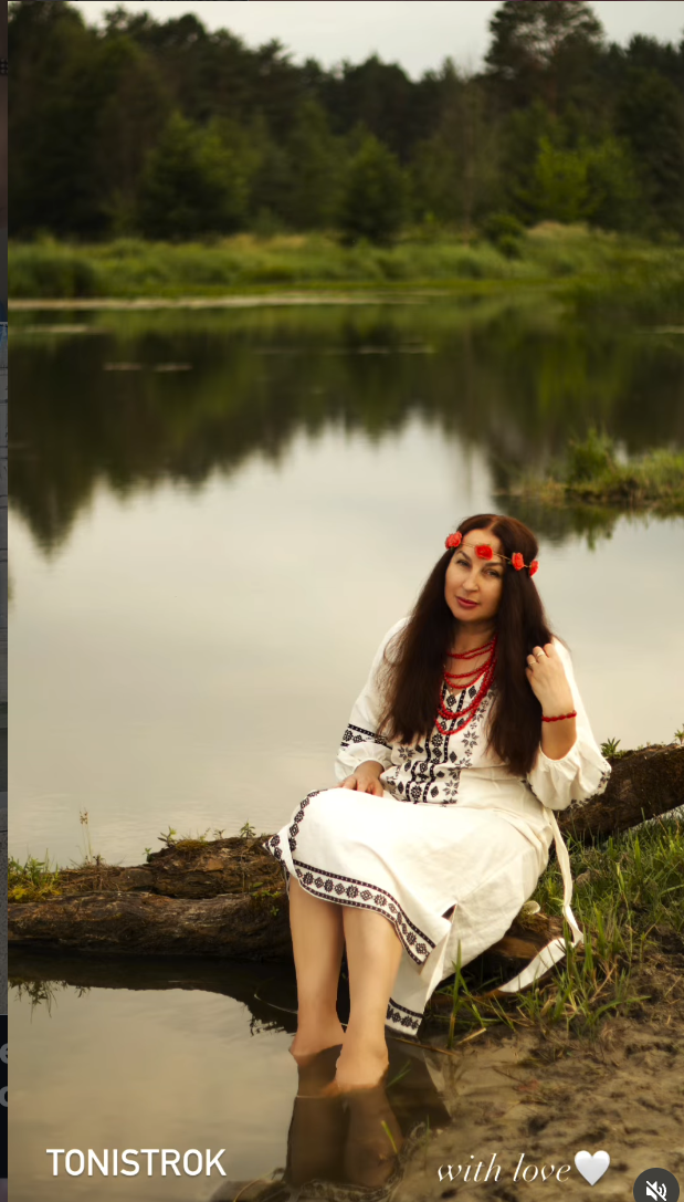 Pavant’s founder by a lake, wearing traditional Ukrainian embroidery