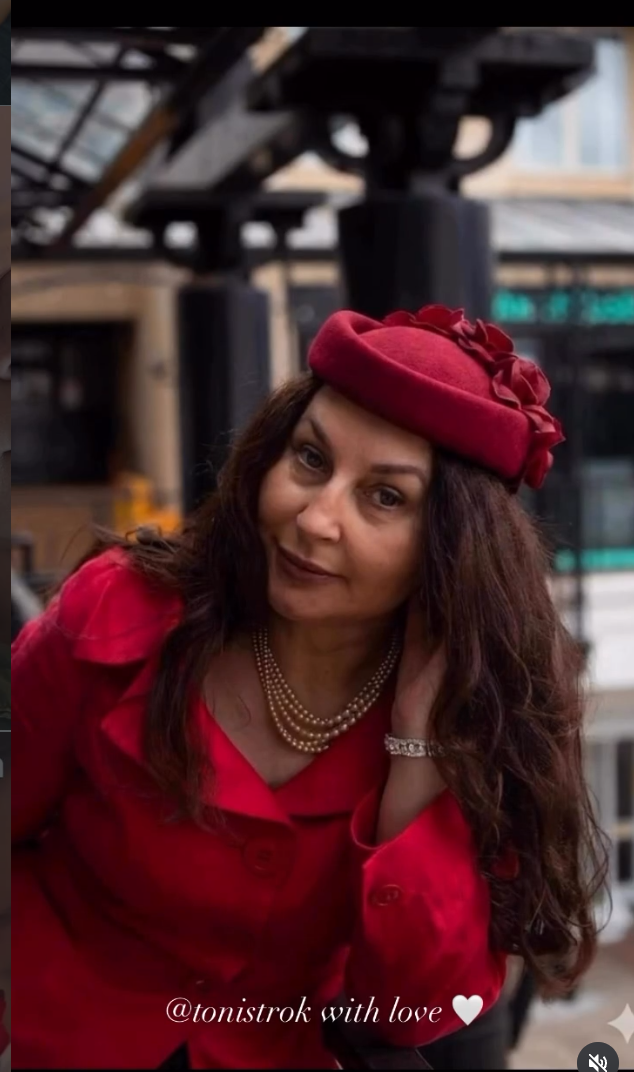 The woman behind Pavant, wearing a red beret